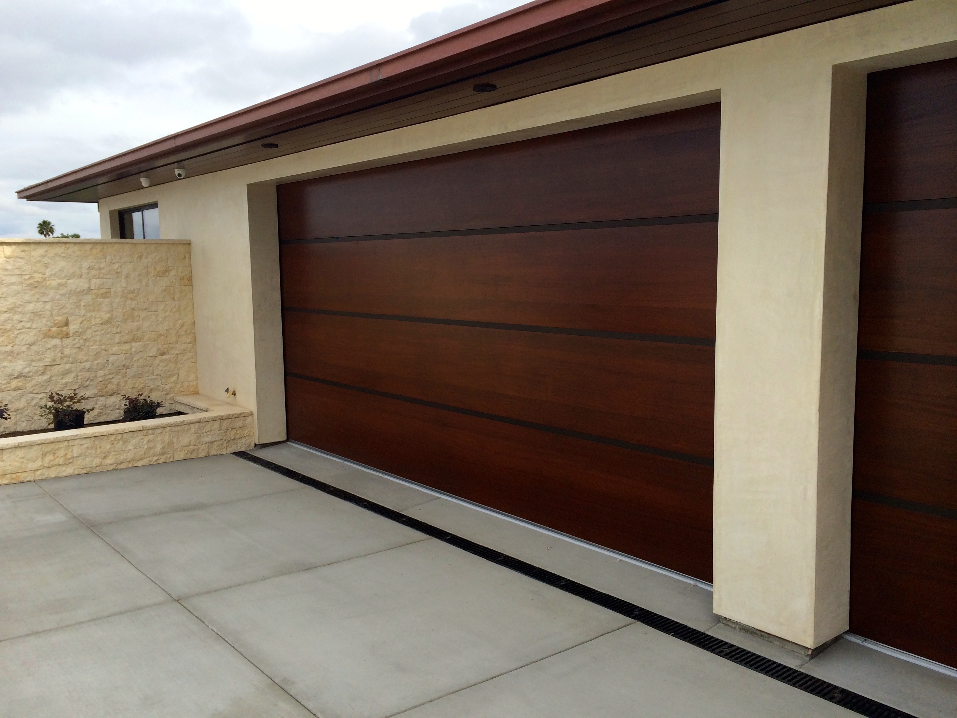 African-Mahogany-Contemporary-Wood-Garage-Door-with-Anodized-Aluminum-Bands-Tungsten-Royce-1